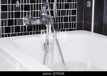 open water from faucet to bathtub in the bathroom Stock Photo