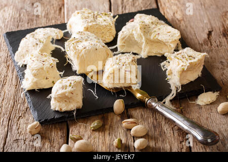 Turkish traditional dessert pismaniye with pistachios close-up on the table. horizontal Stock Photo