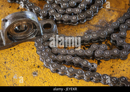 old black roller chain and bearing housing of machine Stock Photo