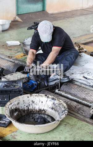 repairman holding a wrench and tighten and during maintenance work of the machine Stock Photo