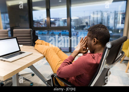 Image of african american businessman working on his laptop. Handsome young man at his desk. Stock Photo