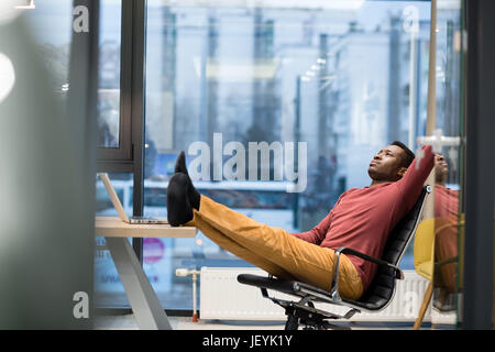 Image of african american businessman working on his laptop. Handsome young man at his desk. Stock Photo