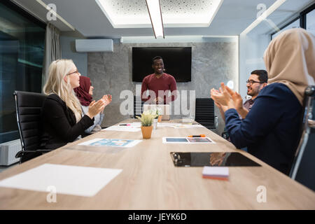 Multi-Cultural Office Staff Sitting Having Meeting Together Stock Photo