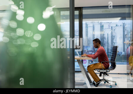 Image of african american businessman working on his laptop. Handsome young man at his desk. Stock Photo