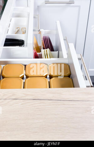 Detailed side view of a kitchen drawers. Diviers onside of the drawer. Modern kitchen making. Contemporary materials. Stock Photo