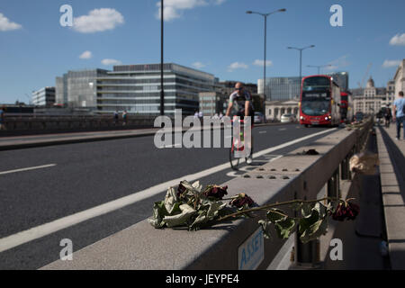 Floral tributes to the terrorist attack in which 7 people were killed at London Bridge, London, England, United Kingdom. A memorial of flowers grew around the crime scene in remembrance to those who died. Londoners on their way to and from the area stop to refelct, read and pay respects at the shrine. Stock Photo
