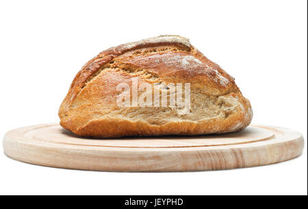 Side view (eye level) of a loaf of crusty wholemeal bread on a light wood chopping board.  Isolated on white background with shadows visible. Stock Photo