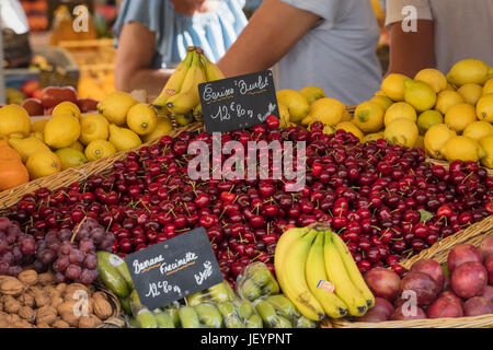 Cherries pears and bananas on sale at a French market stall Stock Photo