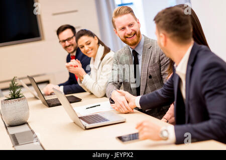 Two business colleagues shaking hands during meeting in office Stock Photo