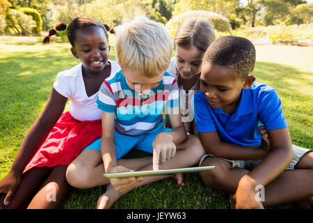 Kids using technology during a sunny day Stock Photo