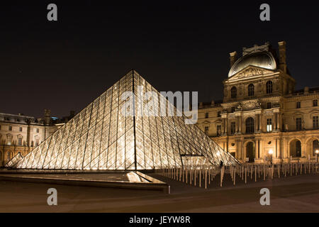 Night view of glass pyramid at Louvre Museum (Musée du Louvre). Former historic palace housing huge art collection, from Roman sculptures to da Vinci' Stock Photo