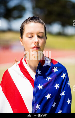 Female athlete wrapped in american flag Stock Photo - Alamy