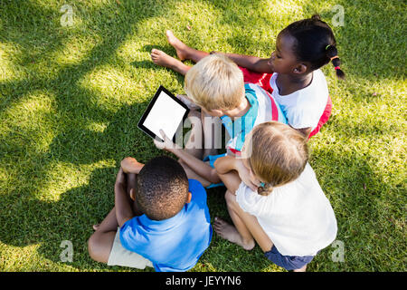 Kids using technology during a sunny day Stock Photo
