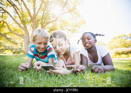 Kids using technology during a sunny day Stock Photo