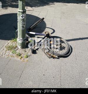 broken bicycle on a street lamp in Berlin Stock Photo