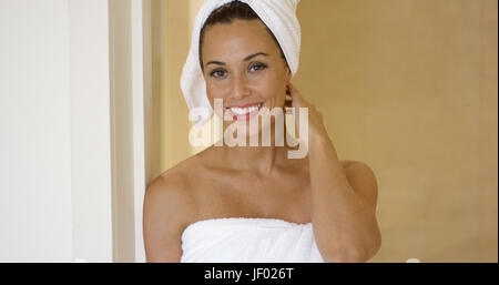 Woman wearing towel and with hair wrapped Stock Photo