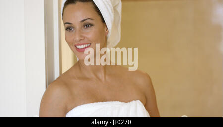 Woman wearing towel and with hair wrapped Stock Photo