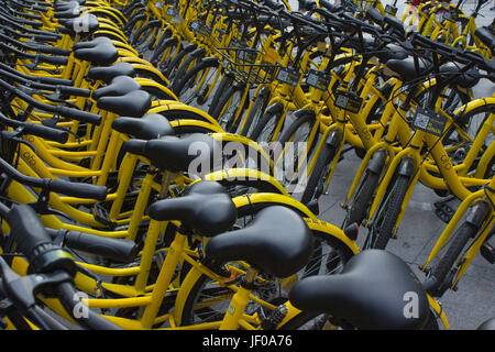 Public bicycles at streets of Shenzhen, Guangdong, People's republic of China; Ofo bike operator - yellow bikes Stock Photo