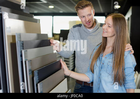 Young couple choosing floor tiles Stock Photo
