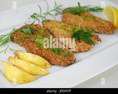 fried fish herrings with vegetables on  plate Stock Photo
