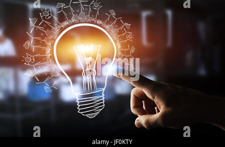 Businesswoman on blurred background touching a sketch lightbulb Stock Photo