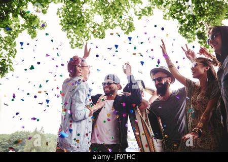 Group of friends dancing in confetti Stock Photo