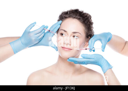 Aesthetic medicine. Young beautiful woman is having botox face injections. Anti-aging skincare and plastic surgery concept. Stock Photo