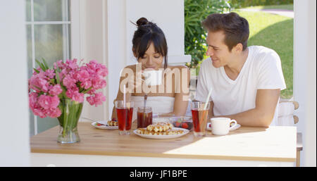 Couple having breakfast at outdoor table Stock Photo