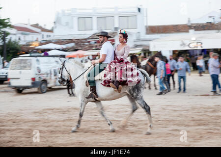 El Rocio, Spain - June 1, 2017: Couple on horseback in  traditional spanish dress in El Rocio during the Romeria 2017. Province of Huelva, Almonte, An Stock Photo