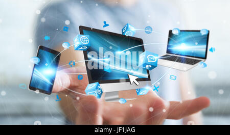 Businessman connecting tech devices and icons applications with each other 3D rendering Stock Photo