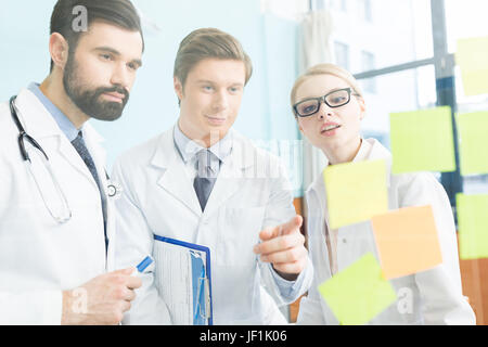 group of concentrated doctors having work meeting in clinic Stock Photo