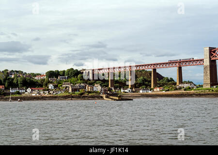 North Queensferry and the Forth Bridge in evening light seen from Firth of Forth Fife  Scotland UK Stock Photo