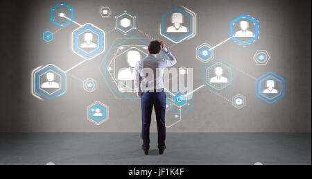 Businessman in modern interior using social network interface on a wall 3D rendering Stock Photo