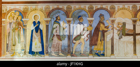 Adoration of the Magi, The holy three kings bring their gifts to the Christchild. Romanesque fresco in Jelling church, Denmark - June 26, 2017 Stock Photo