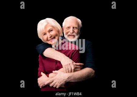 senior couple smiling and embracing isolated on black, senior couple happy concept Stock Photo