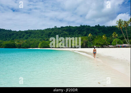 Tourist wandering along the turquoise water and white sand at the Champagne beach, Island of Espiritu Santo, Vanuatu, South Pacific, MR Stock Photo