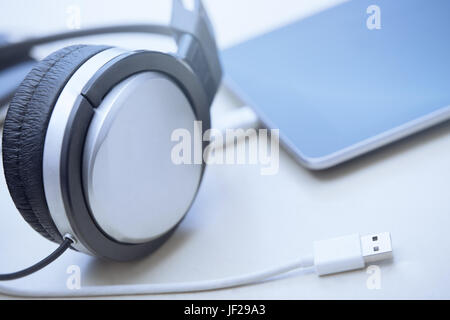 Headphones digital tablet and USB cable Stock Photo