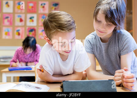 Boys using digital tablet Stock Photo