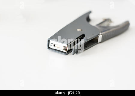 gray stapler on a white plain Stock Photo
