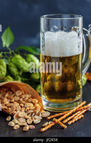 Salted sticks, peanuts and mug of beer. Stock Photo