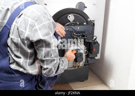 fixing an oil burner Stock Photo