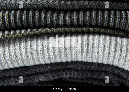 Stack of gray woolen knitted sweaters Stock Photo