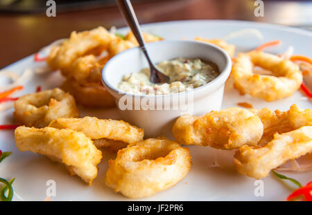 Deep fried calamari rings with sauce bowl Stock Photo