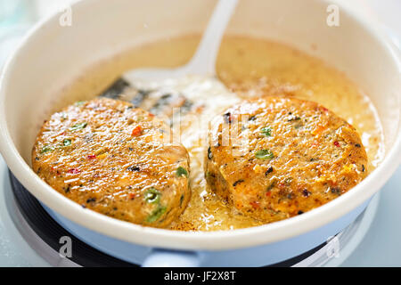 Salmon hake fishcakes with vegetables Stock Photo