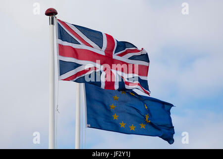 European Union and British Union Jack flags blow in the wind. The UK voted to leave the EU in a referendum. Stock Photo