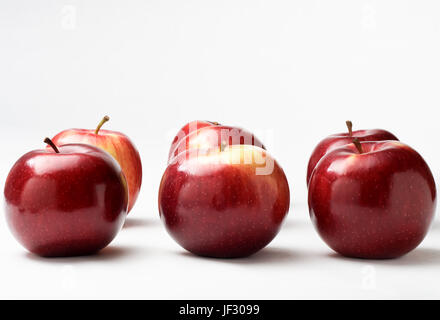 Seven shiny red apples in two rows of three with one at the back. Stock Photo