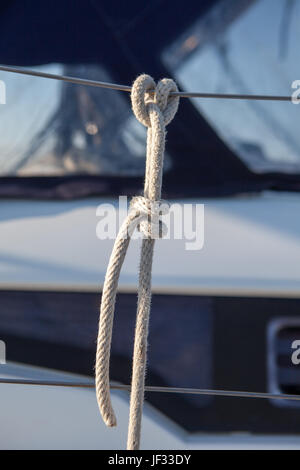 Rope tied to the railing on the boat a clove hitch Stock Photo
