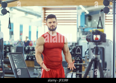 Vlogger athlete makes a video about healthy eating in the gym. Stock Photo