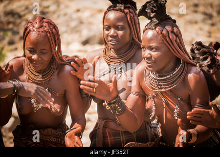 Traditional Himba women in typical dress in the Damaraland region of northern Namibia, in southern Africa. Stock Photo