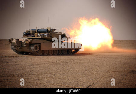 050124-M-8479B-004 U.S. Marines fire the main gun of their M1A1 Abrams tank in the western desert of the Najaf Province of Iraq during a training exercise on Jan. 24, 2005.  The Marines, assigned to Tank Platoon, Battalion Landing Team 1st Battalion, 4th Marines, 11th Marine Expeditionary Unit Special Operations Capable train monthly to maintain proficiency.  DoD photo by Gunnery Sgt. Robert K. Blankenship, U.S. Marine Corps.  (Released) Stock Photo